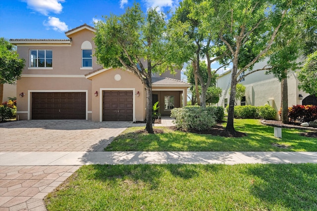 1317 Beacon Cir, Wellington, FL 33414 - view of front facade with stucco siding, a tile roof, a front lawn, and decorative driveway