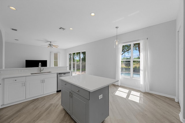 1317 Beacon Cir, Wellington, FL 33414 - kitchen with dishwasher, a sink, light wood-style floors, healthy amount of natural light, and recessed lighting