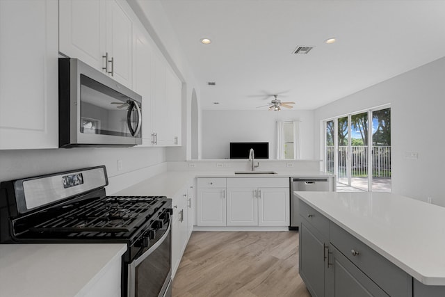 1317 Beacon Cir, Wellington, FL 33414 - kitchen featuring appliances with stainless steel finishes, light countertops, a ceiling fan, light wood-style floors, and recessed lighting