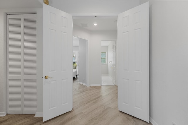1317 Beacon Cir, Wellington, FL 33414 - corridor featuring baseboards, light wood finished floors, and recessed lighting