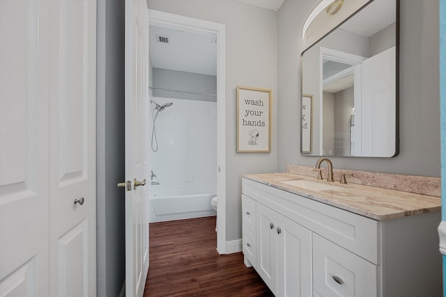 1317 Beacon Cir, Wellington, FL 33414 - full bath featuring wood finished floors, toilet, vanity, baseboards, and shower / bath combination
