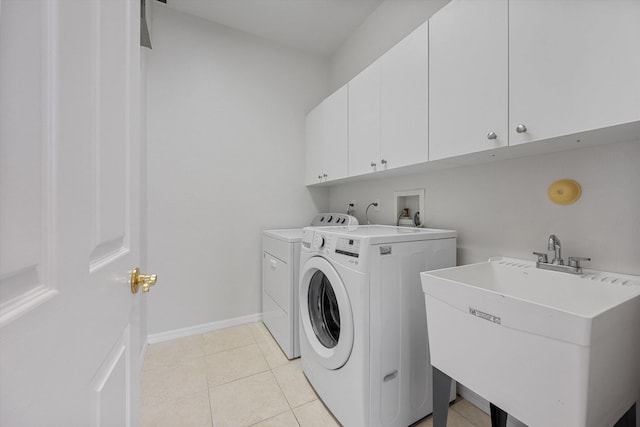 1317 Beacon Cir, Wellington, FL 33414 - laundry area featuring cabinet space, washing machine and dryer, light tile patterned floors, and baseboards