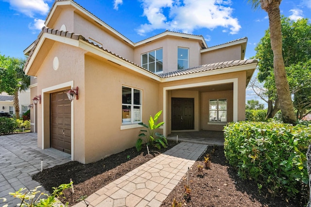 1317 Beacon Cir, Wellington, FL 33414 - view of front of home with stucco siding, a garage, and a tile roof