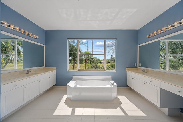 1317 Beacon Cir, Wellington, FL 33414 - bathroom featuring baseboards, two vanities, healthy amount of natural light, and a bath
