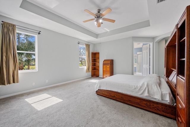 1317 Beacon Cir, Wellington, FL 33414 - carpeted bedroom with a raised ceiling, multiple windows, and baseboards