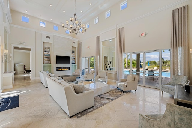 1317 Beacon Cir, Wellington, FL 33414 - living room with a high ceiling, a chandelier, a glass covered fireplace, recessed lighting, and baseboards