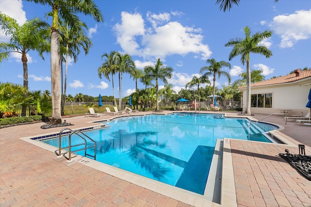 1317 Beacon Cir, Wellington, FL 33414 - community pool featuring a patio and fence
