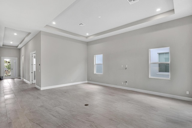 10148 Driftwood Way, Palm Beach Gardens, FL 33412 - unfurnished room featuring a raised ceiling, plenty of natural light, baseboards, and recessed lighting