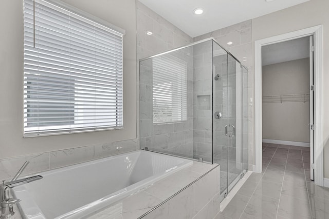 10148 Driftwood Way, Palm Beach Gardens, FL 33412 - bathroom with a garden tub, a stall shower, a spacious closet, recessed lighting, and baseboards