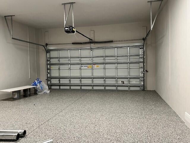 10148 Driftwood Way, Palm Beach Gardens, FL 33412 - garage featuring a garage door opener