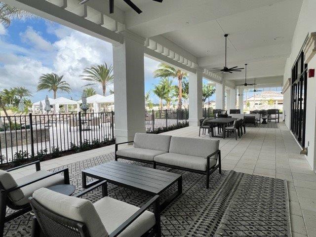 view of patio featuring fence, a ceiling fan, outdoor dining area, and an outdoor living space