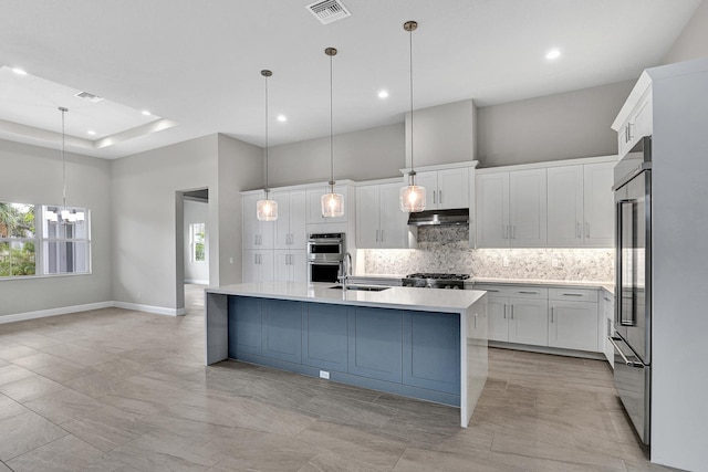 10148 Driftwood Way, Palm Beach Gardens, FL 33412 - kitchen featuring under cabinet range hood, stainless steel appliances, decorative backsplash, light countertops, and a sink