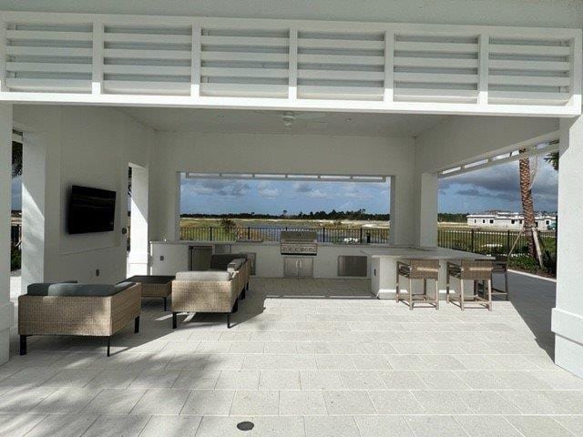 10148 Driftwood Way, Palm Beach Gardens, FL 33412 - view of patio / terrace featuring exterior bar and an outdoor kitchen