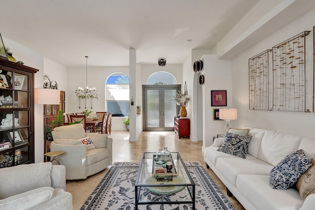 living room featuring a chandelier, french doors, and light tile patterned flooring