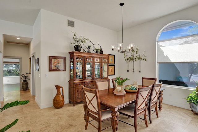 dining space with a chandelier and baseboards