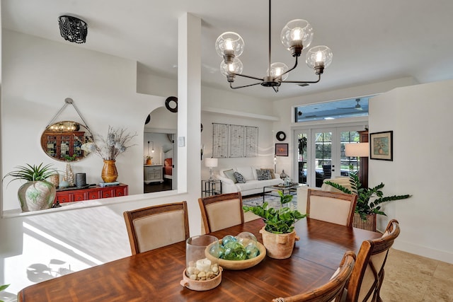 dining space with a chandelier and french doors