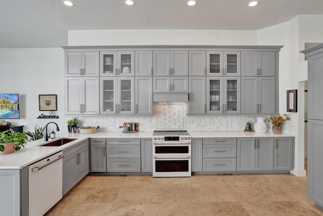 kitchen with white appliances, gray cabinetry, a sink, and recessed lighting