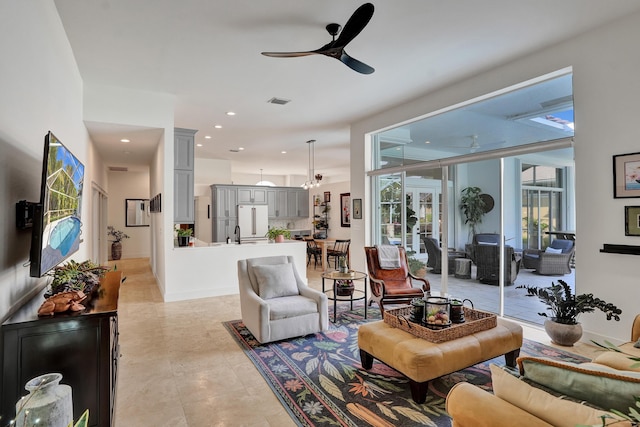 living area with ceiling fan and recessed lighting