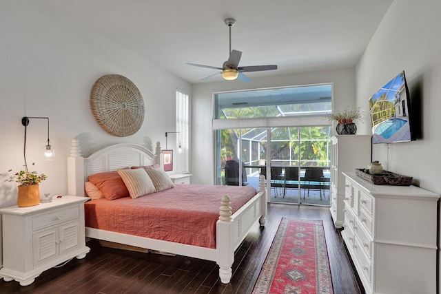 bedroom with access to outside, dark wood finished floors, multiple windows, and a sunroom