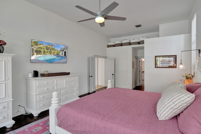 bedroom with wood finished floors, lofted ceiling, baseboards, and a ceiling fan