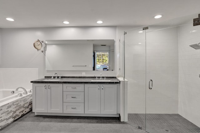 bathroom with a shower stall, a garden tub, double vanity, recessed lighting, and tile patterned flooring