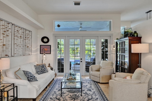 living room with french doors and a ceiling fan