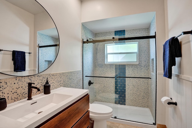 full bath featuring a shower stall, decorative backsplash, toilet, and vanity