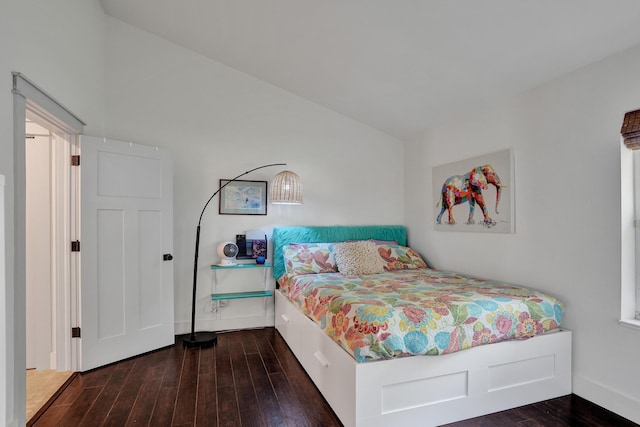 bedroom featuring wood finished floors and baseboards