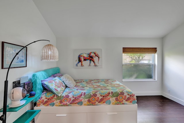 bedroom with wood finished floors and baseboards