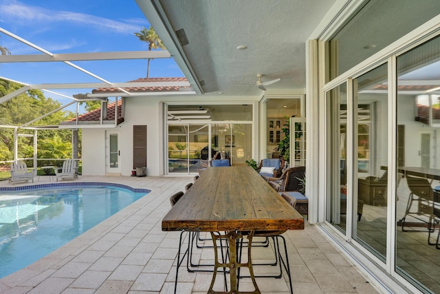 outdoor pool with a patio and a lanai