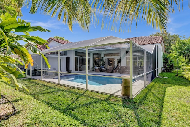 swimming pool featuring a patio, glass enclosure, a yard, and outdoor lounge area