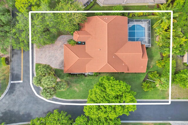 aerial view of residential area with a nearby body of water and property parcel outlined