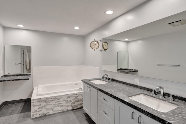 full bath with double vanity, a bath, recessed lighting, and tile patterned flooring