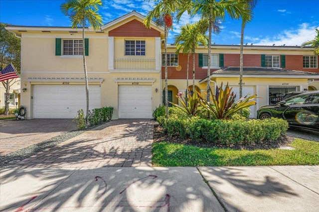 4738 Sundance Way, Davie, FL 33328 - view of property featuring stucco siding, an attached garage, and decorative driveway