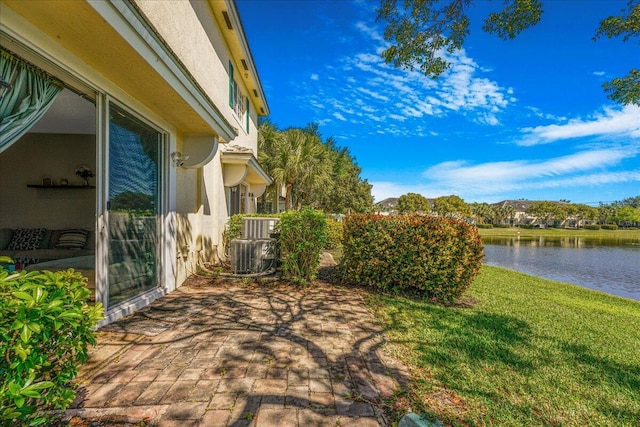 4738 Sundance Way, Davie, FL 33328 - exterior space with a water view, central AC unit, stucco siding, and a lawn