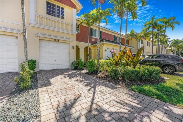 4738 Sundance Way, Davie, FL 33328 - view of front of property with stucco siding, an attached garage, and decorative driveway