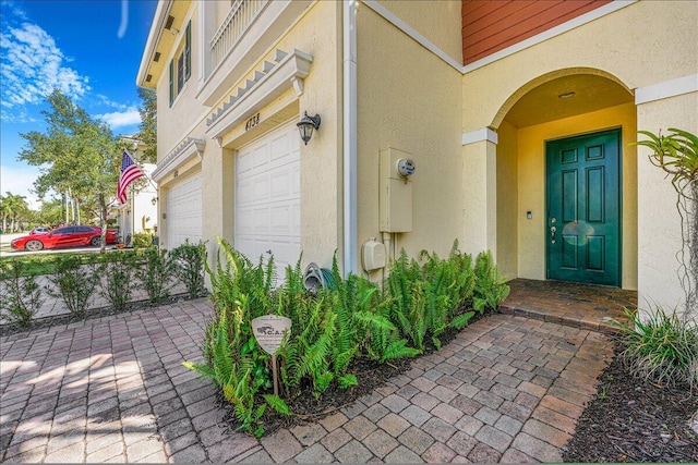 4738 Sundance Way, Davie, FL 33328 - property entrance featuring an attached garage, driveway, and stucco siding