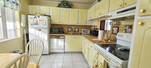kitchen with white appliances, light tile patterned floors, a toaster, under cabinet range hood, and ornamental molding