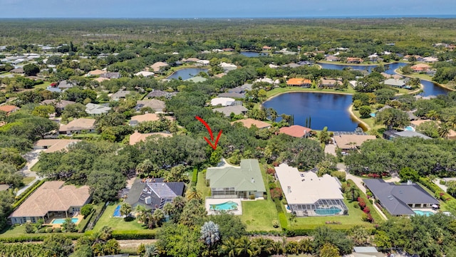 aerial view of residential area with a nearby body of water and a pool area