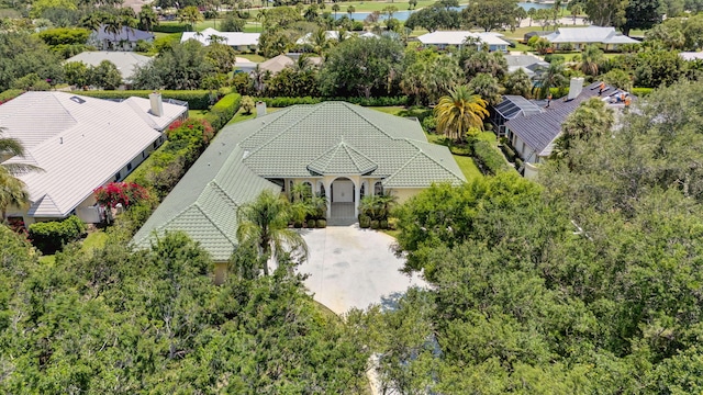 aerial view of property and surrounding area with a tree filled landscape