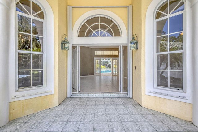 view of exterior entry featuring stucco siding