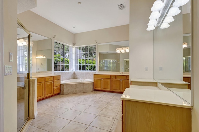 full bath featuring a stall shower, a bath, and two vanities