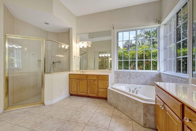 full bathroom featuring a garden tub, a stall shower, tile patterned flooring, and vanity
