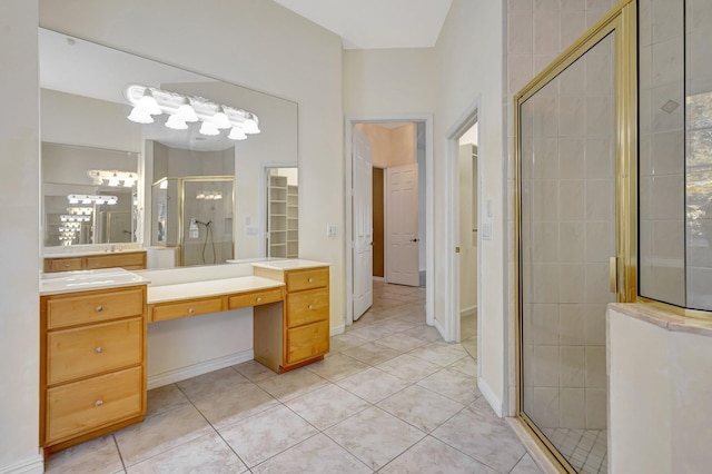 bathroom featuring a shower stall, tile patterned flooring, a chandelier, and vanity