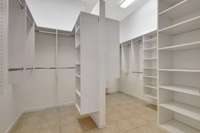 spacious closet with light tile patterned floors