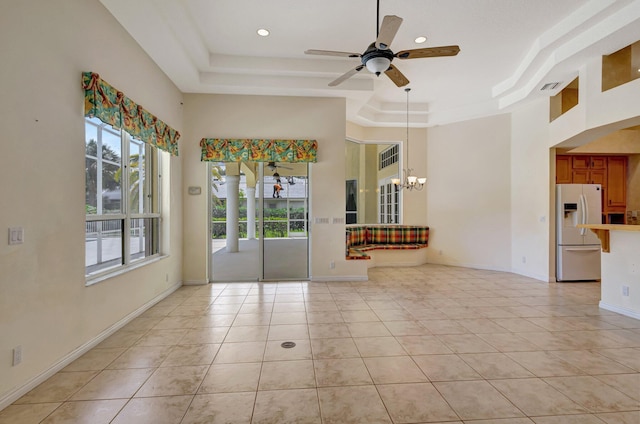 unfurnished room with a raised ceiling, healthy amount of natural light, ceiling fan, light tile patterned floors, and recessed lighting