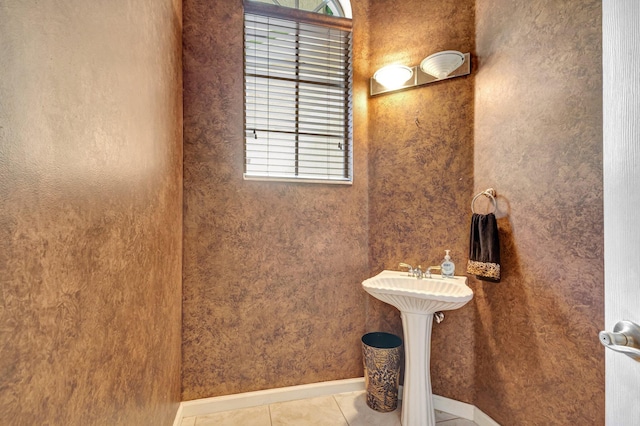 bathroom with baseboards and tile patterned flooring