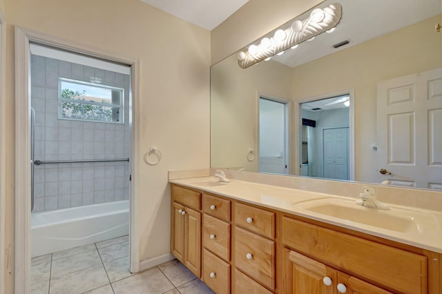 full bathroom featuring tile patterned flooring, double vanity, shower / washtub combination, and baseboards