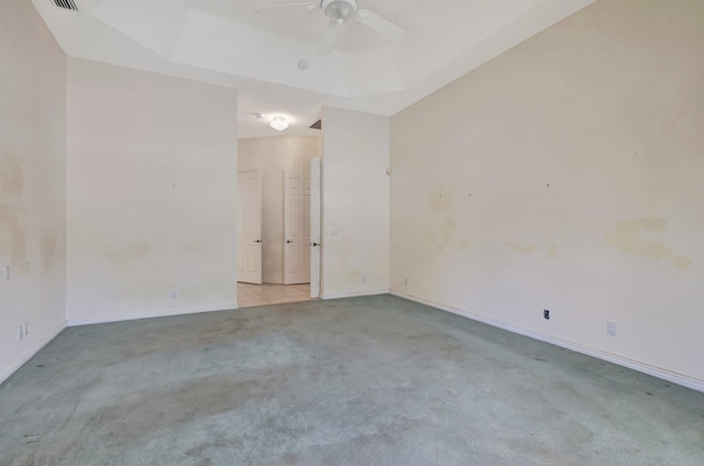 carpeted empty room with ceiling fan and baseboards