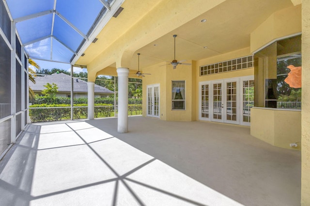unfurnished sunroom featuring french doors and a ceiling fan
